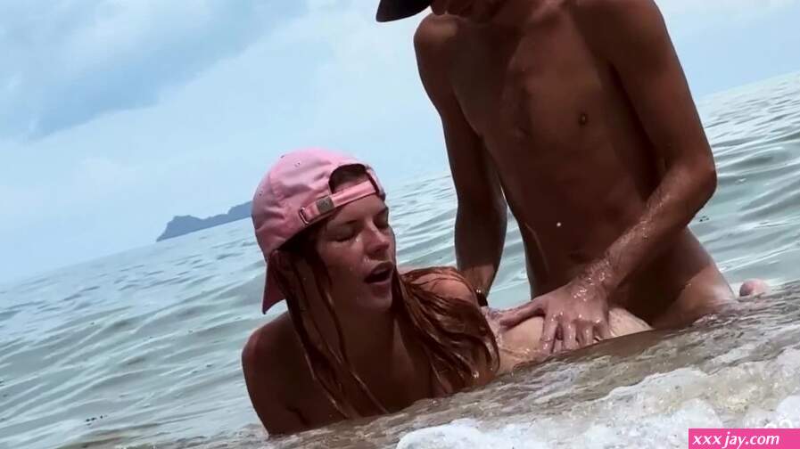 Wild Angel gets fuck in the sea waves on the public nude beach