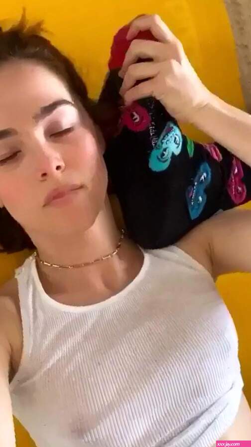 Zoey Deutch shows her small tits posing in a white top without a bra